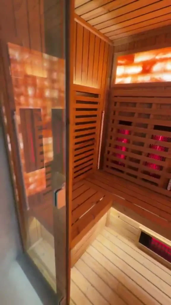 Backlit Himalayan salt wall and benches inside the Project 01 sauna in Dubai